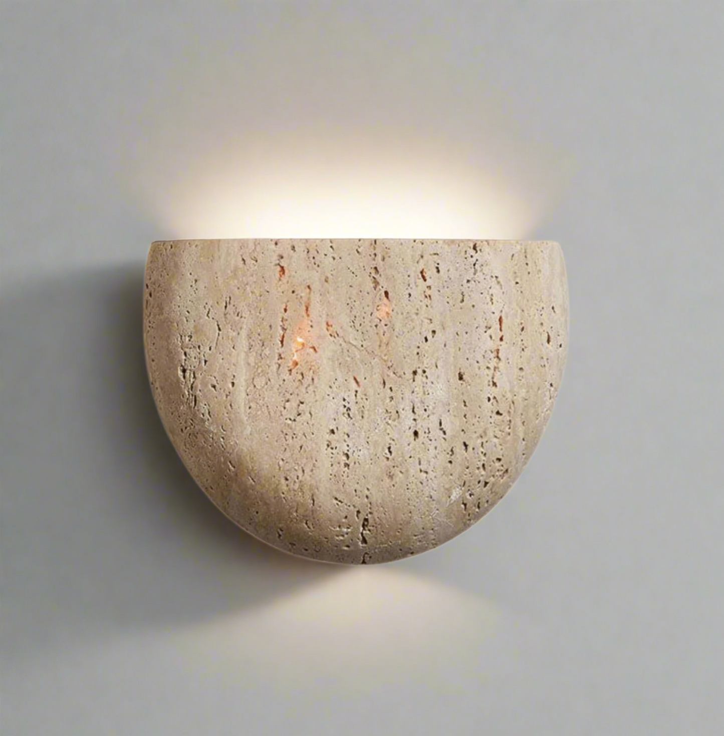 Natural stone wall sconce in beige finish on white background 