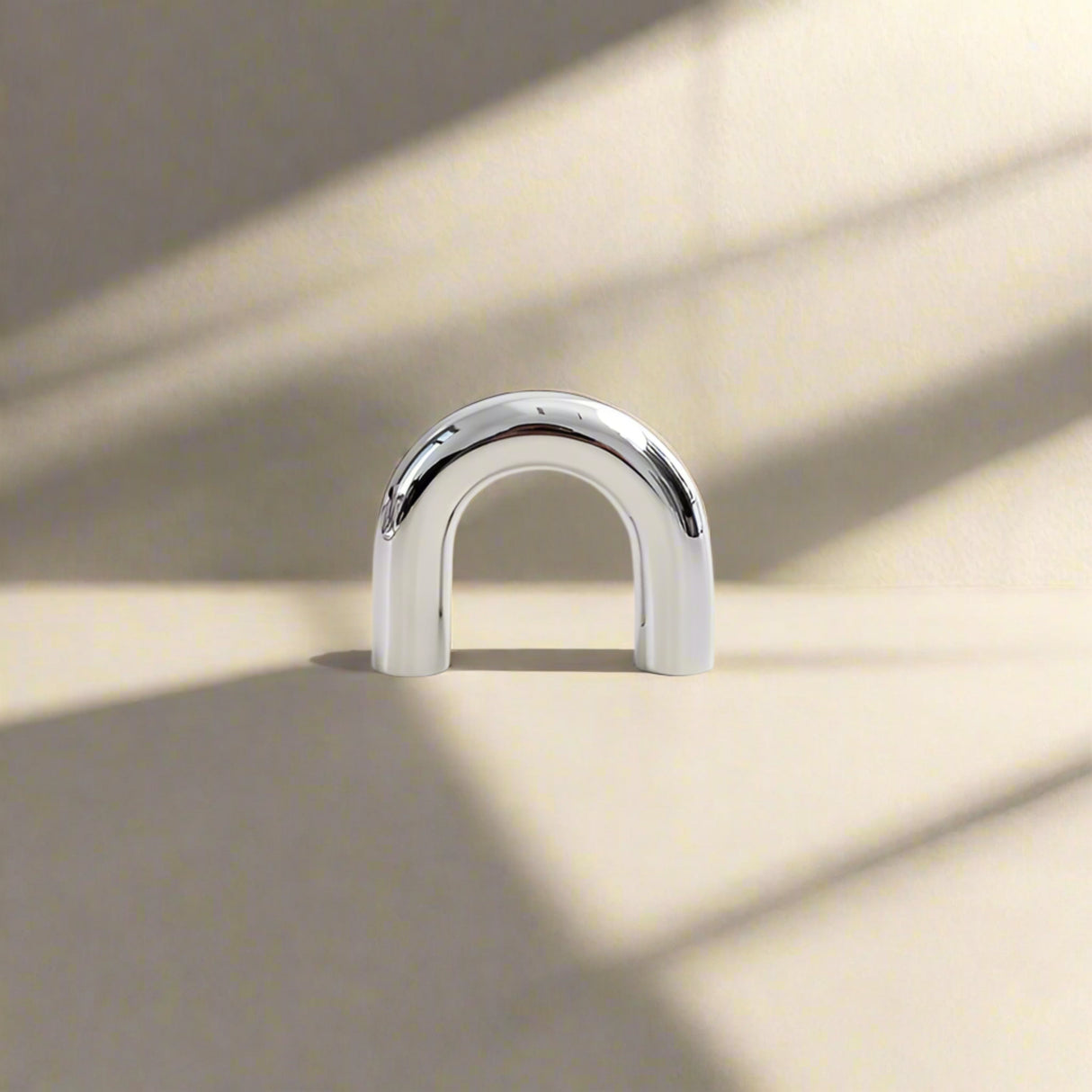 Metallic U-shaped cabinet pull  on a white background