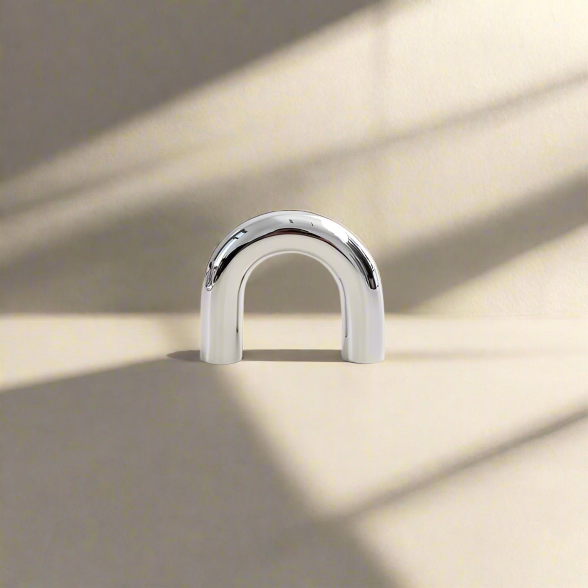 Metallic U-shaped cabinet pull  on a white background