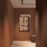Decorative wall art in a room with brown walls and a door.