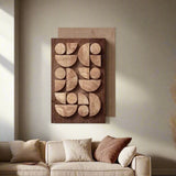 Wooden wall art with geometric shapes on a beige wall above a sofa.
