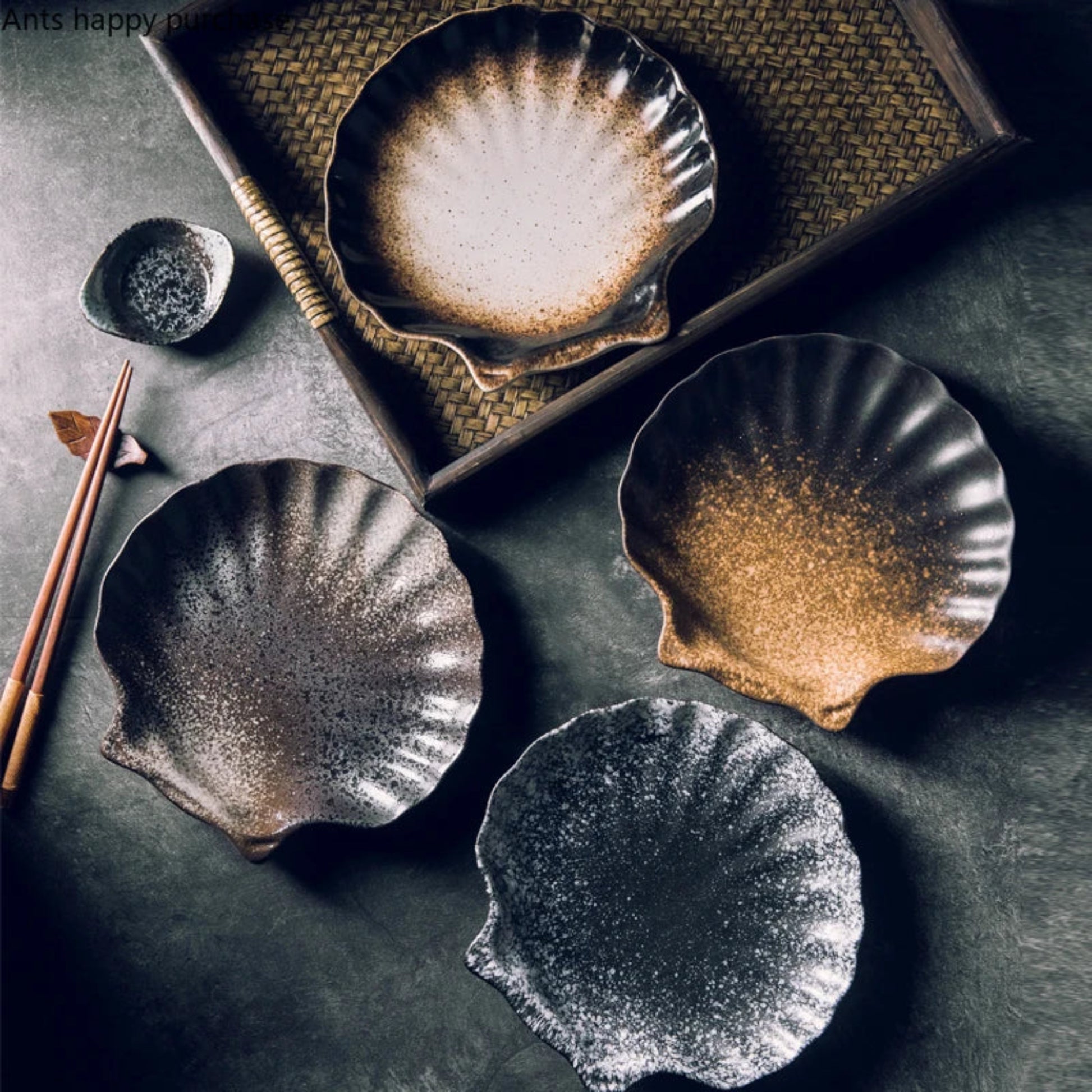 Set of ceramic plates with textured surfaces on a dark surface.