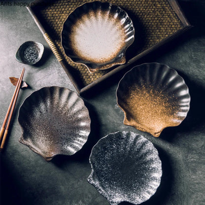 Set of ceramic plates with textured surfaces on a dark surface.