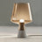 UrbanGlow Cement & Glass Table Lamp styled in a bedroom — modern interior by Baskoraa