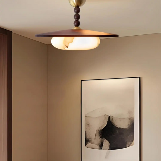 Ceiling light fixture with a framed abstract painting on the wall below.