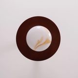 Round wooden coaster with a white center and brown rim on a light gray background