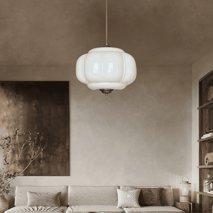 Modern living room with a pendant light fixture, neutral decor, and a sofa.