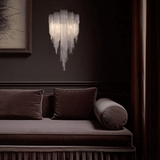 Decorative wall light fixture above a brown sofa with cushions.