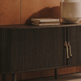 Wooden cabinet with gold humanoid handles