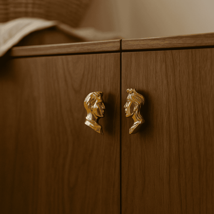 Wooden cabinet with gold face-shaped handles