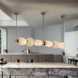 Modern pendant light fixture with glass shades on a beige background