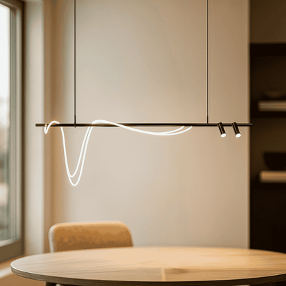 Modern pendant light hanging above a dining table with a neutral background
