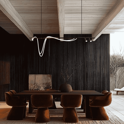 Modern dining area with a long wooden table and brown chairs in a stylish interior setting.