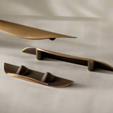 Set of bronze-colored shelves on a beige background