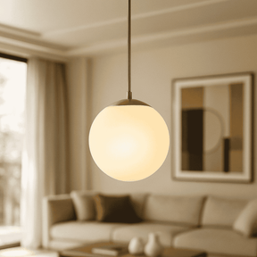 Modern pendant light hanging in a living room with a blurred background