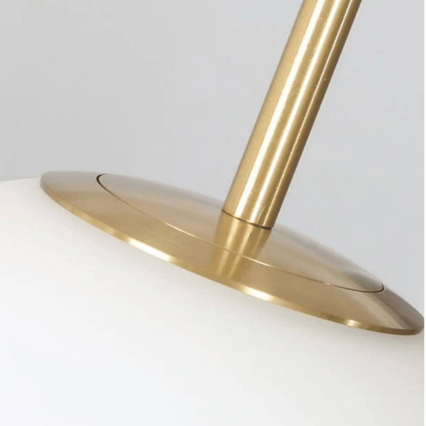 Close-up of a gold lamp base on a white background