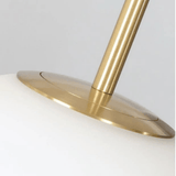 Close-up of a gold lamp base on a white background