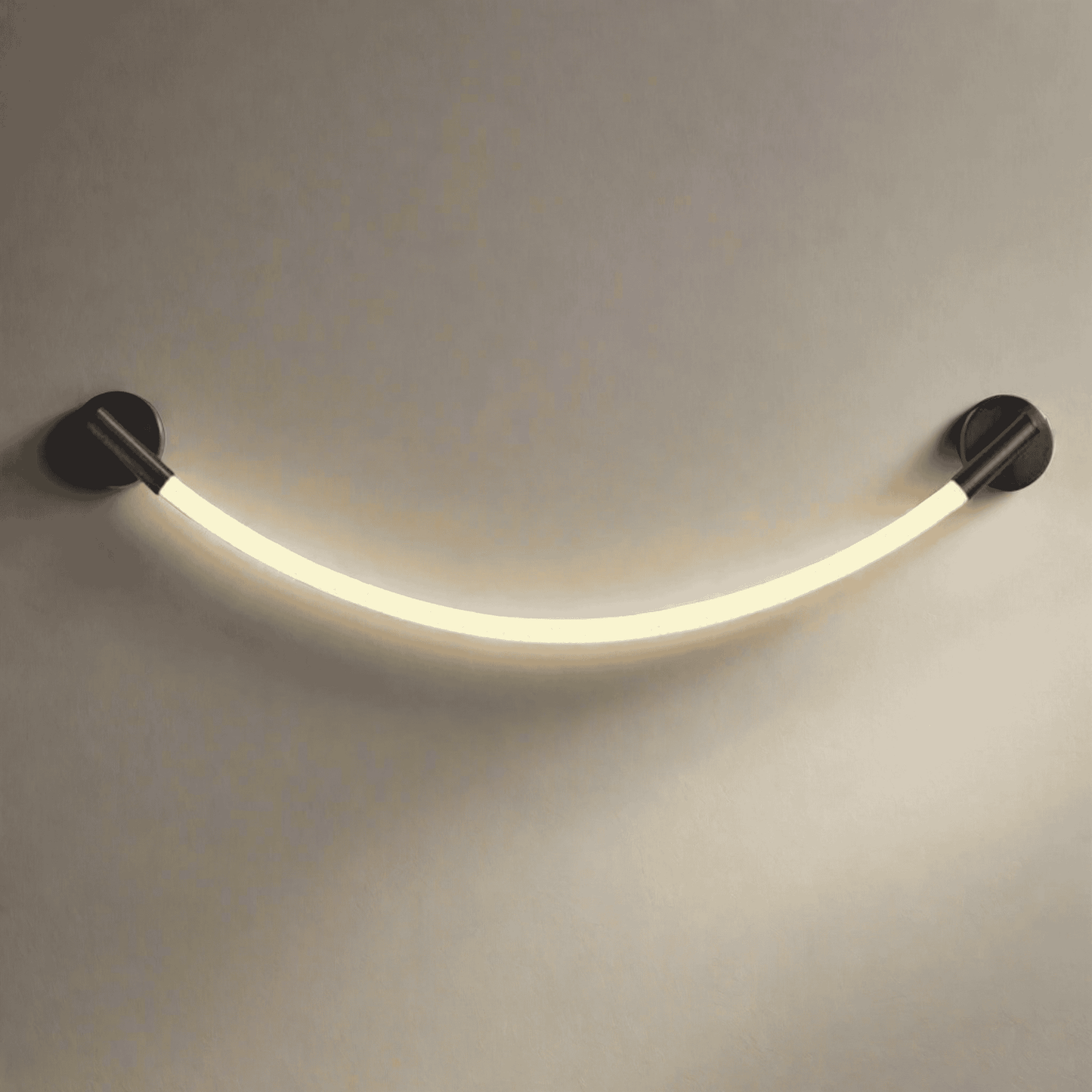 Curved LED wall light fixture on a neutral background