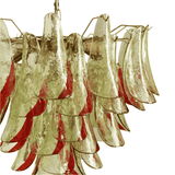 Decorative chandelier with red and gold glass shades on a white background