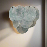 Set of six teal glass bowls stacked on a beige background