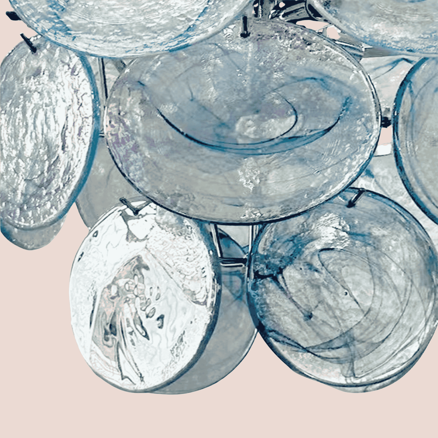 Close-up of a chandelier with glass shades on a light pink background