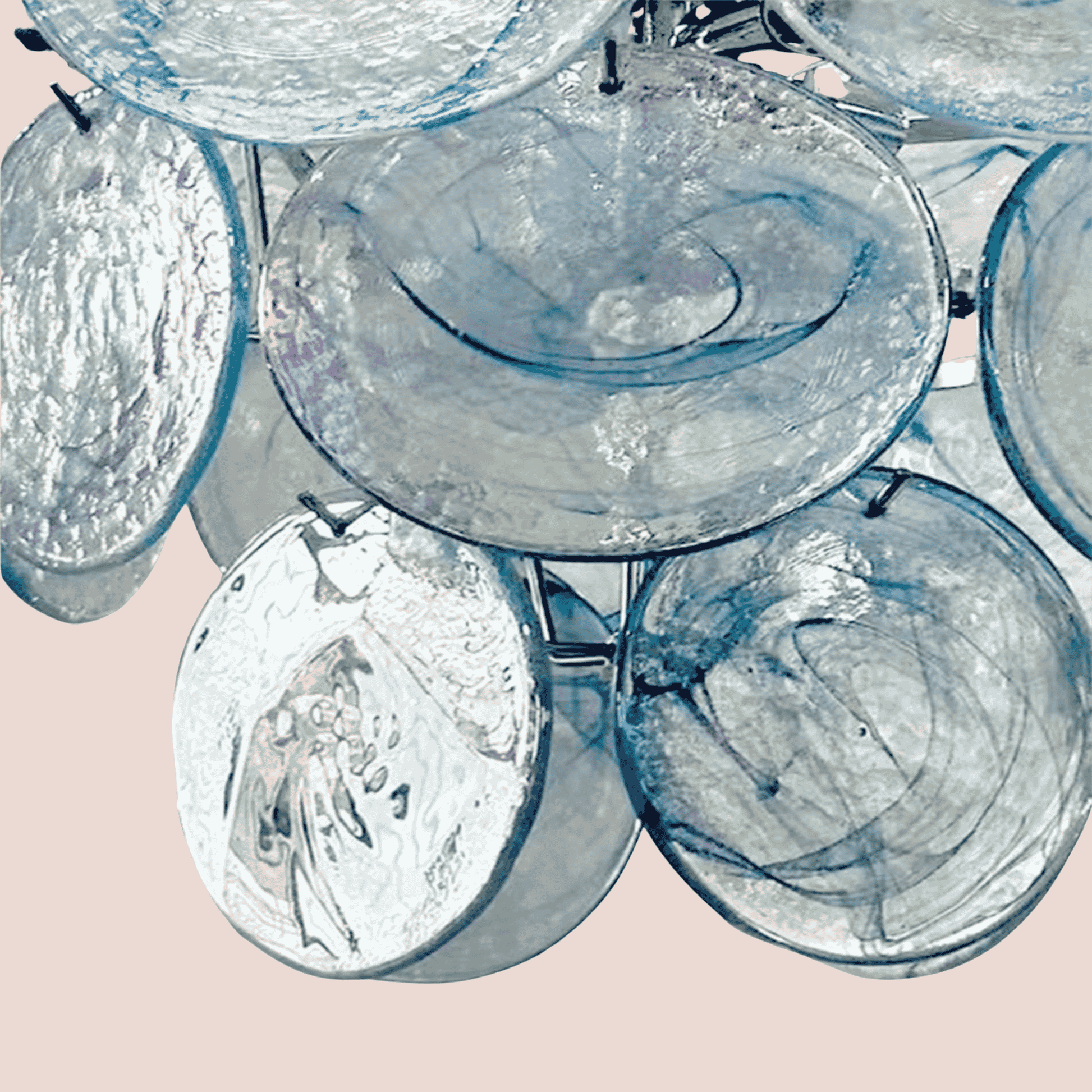 Close-up of a chandelier with glass shades on a light pink background