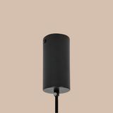 Black cylindrical outdoor light fixture on a white background