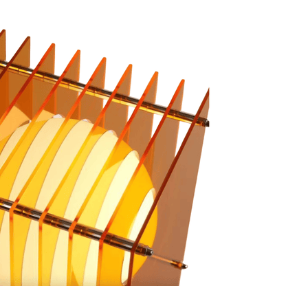 Close-up of a sailboat model with orange sails on a white background