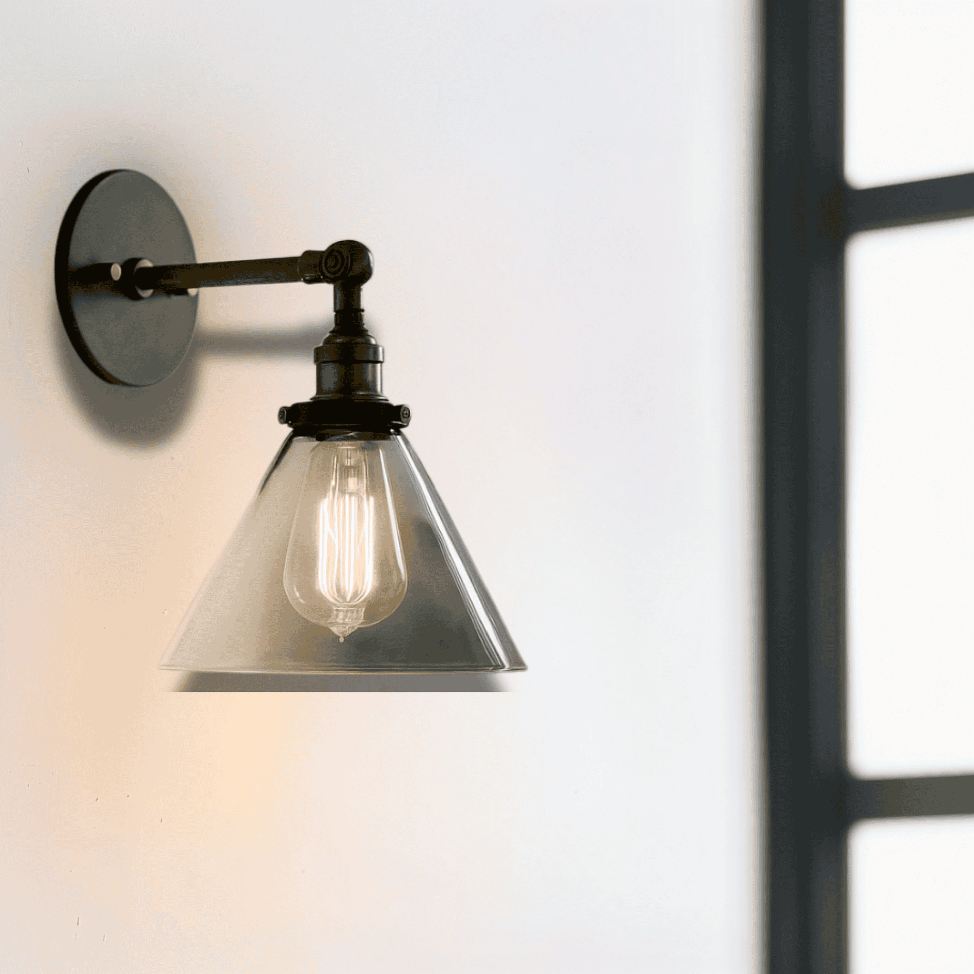 Cone-shaped Retro Glass Wall Sconce with black and brass finish, mounted near a window. Ideal for modern bedrooms or dining room decor.