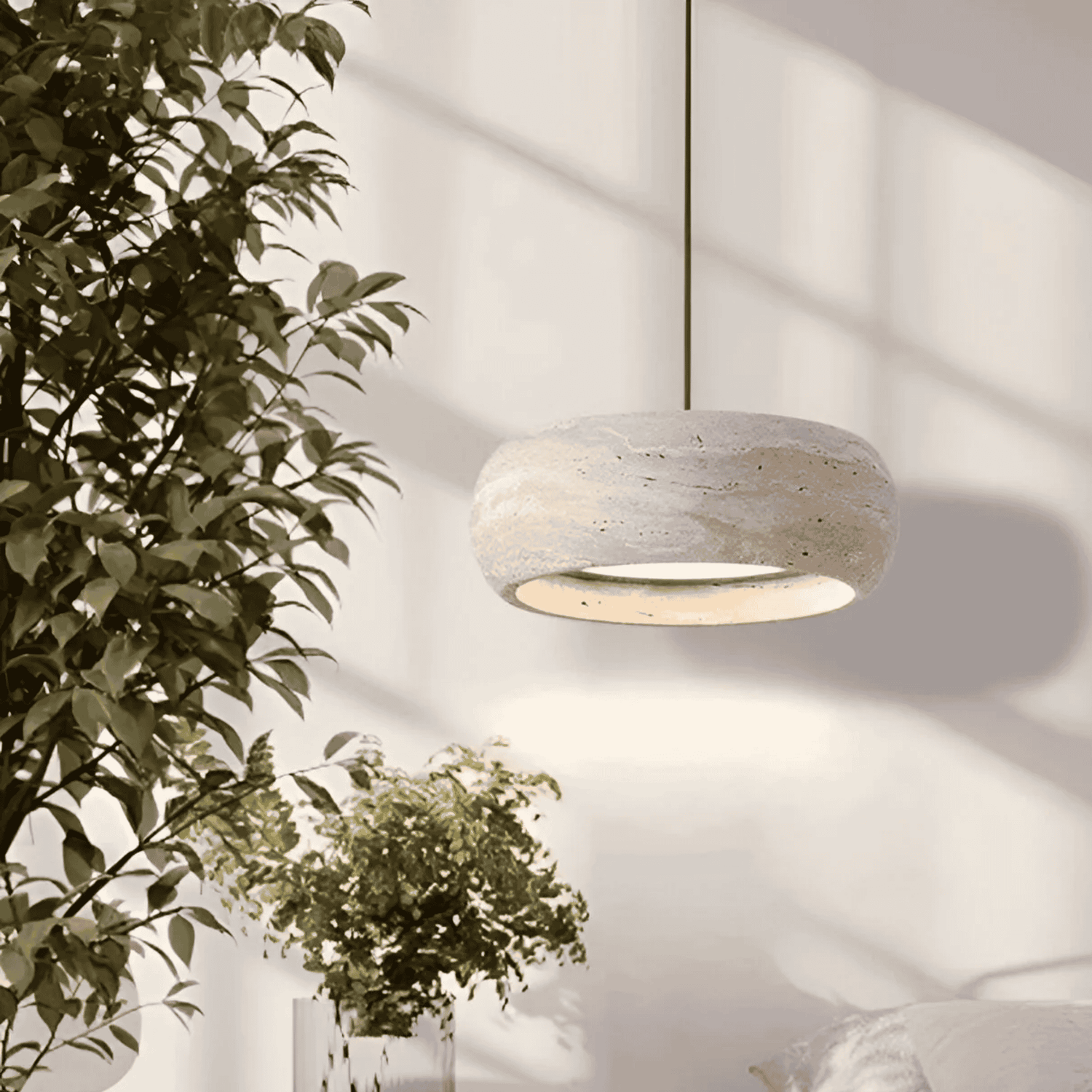 Ithaca travertine LED pendant lamp suspended in a bright bedroom setting, offering dimmable lighting for cozy and elegant ambiance.