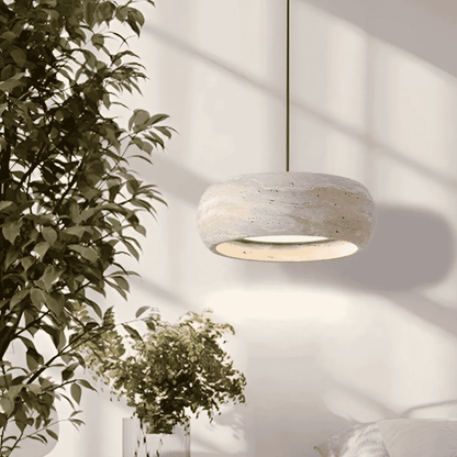 Ithaca travertine LED pendant lamp suspended in a bright bedroom setting, offering dimmable lighting for cozy and elegant ambiance.