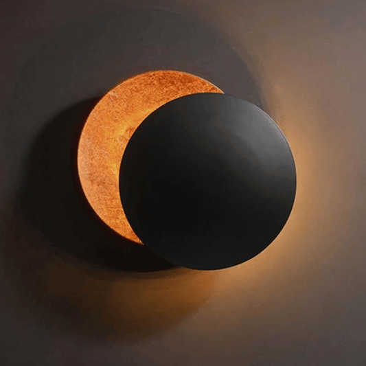Moon Eclipse LED Wall Light partially rotated, emitting warm ambient glow. Ideal for modern living room or bedside lighting.