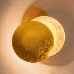 Fully illuminated Moon Eclipse LED Wall Light with golden glow. Stylish round design for modern home lighting and decor.