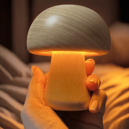 Mushroom-shaped lamp held in a hand with a warm glow