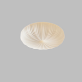 Ceiling light fixture with ribbed design on a beige background