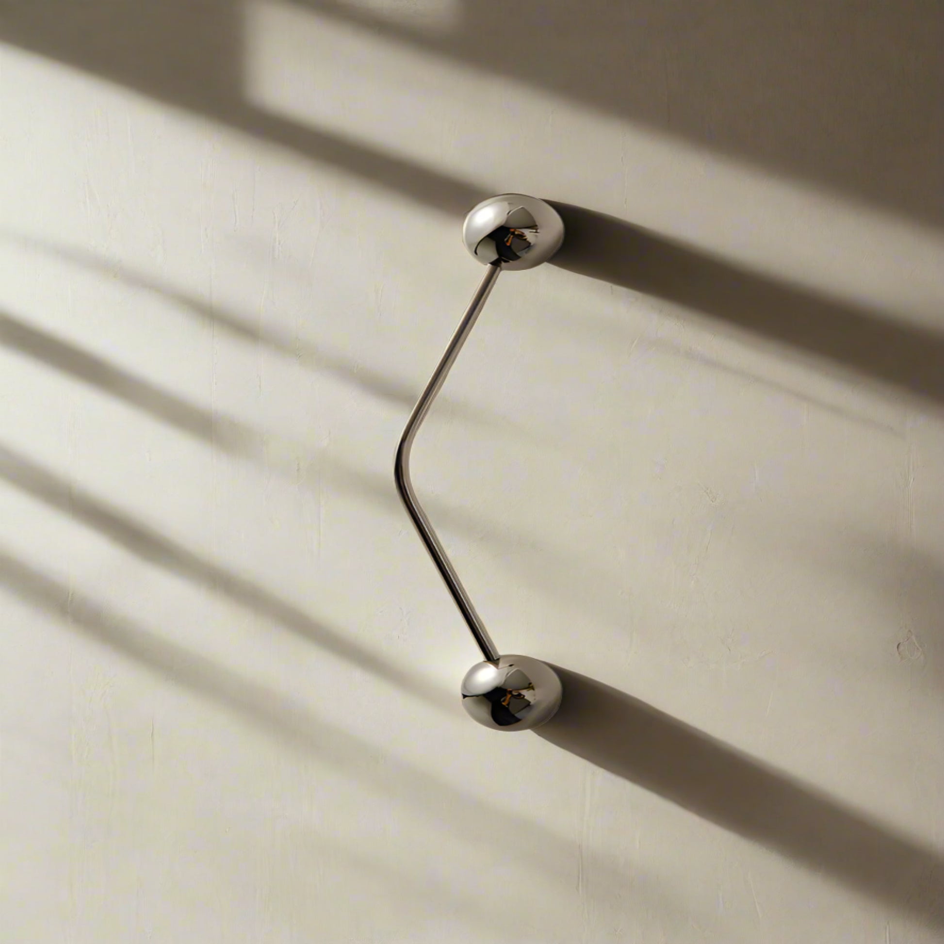 Silver door handles on a beige wall