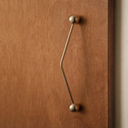 Wooden door with a brass handle on a neutral background