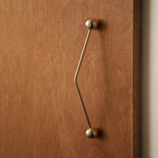 Wooden door with a brass handle on a neutral background
