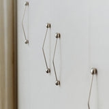 Silver door hanldes on a light gray background.