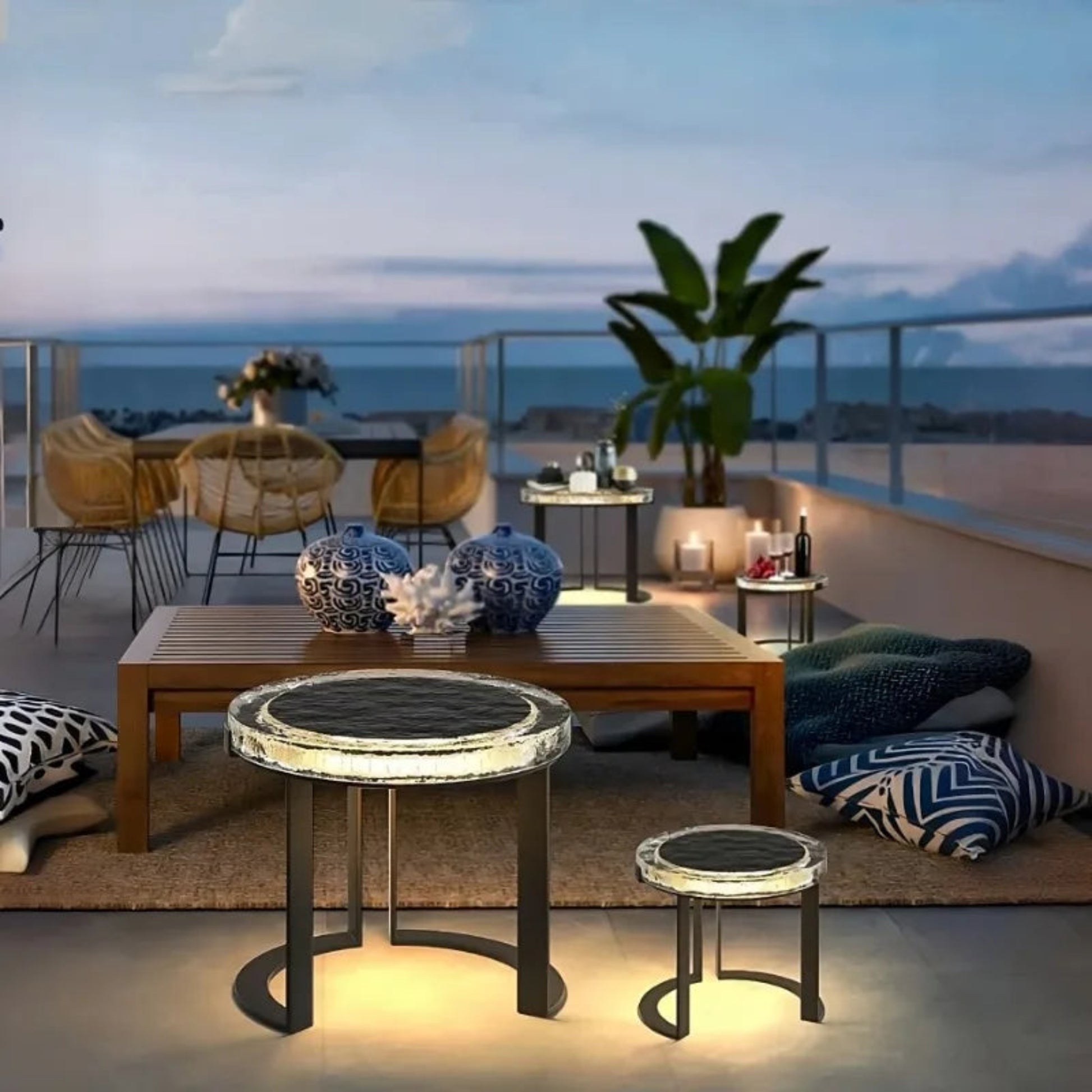 Modern outdoor patio with furniture and decor on a rooftop at night.