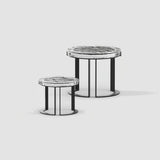 Two round side tables with marble tops and black metal bases on a light gray background