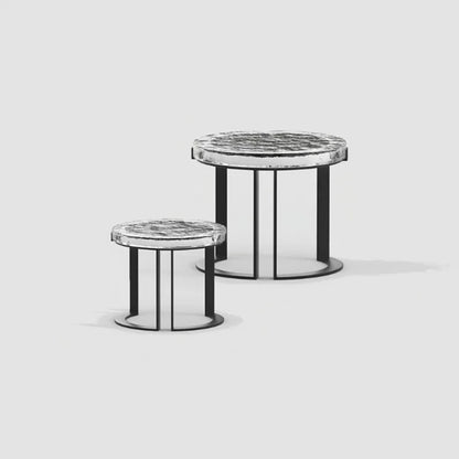 Two round side tables with marble tops and black metal bases on a light gray background