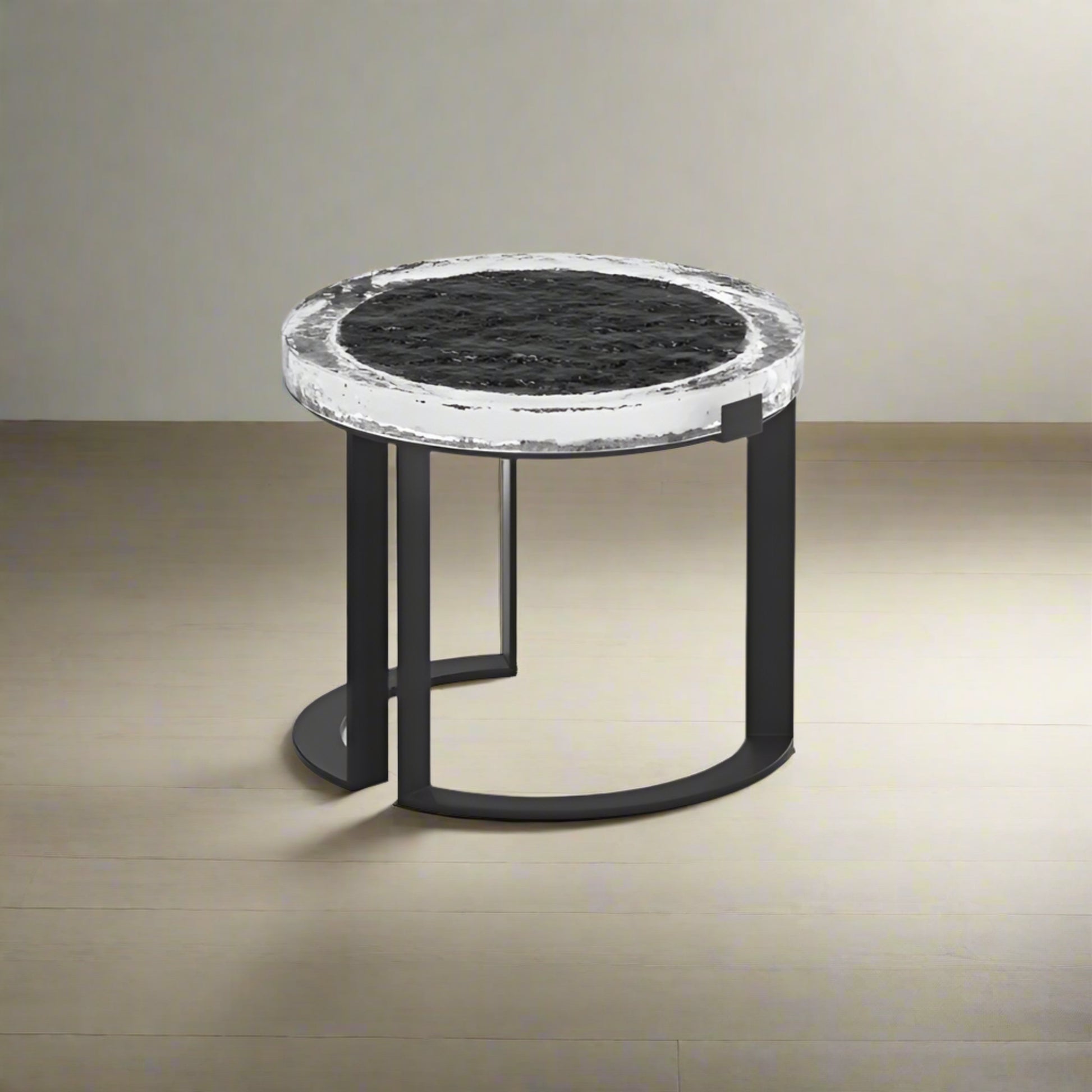 Small round table with marble top and black metal frame on a light gray background