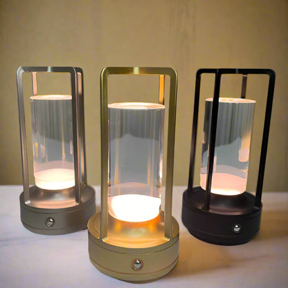 Three touch control LED lamps with varying finishes on a soft fabric background.