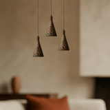 Elegant pendant light  that combines vintage walnut and copper finishes in living room.