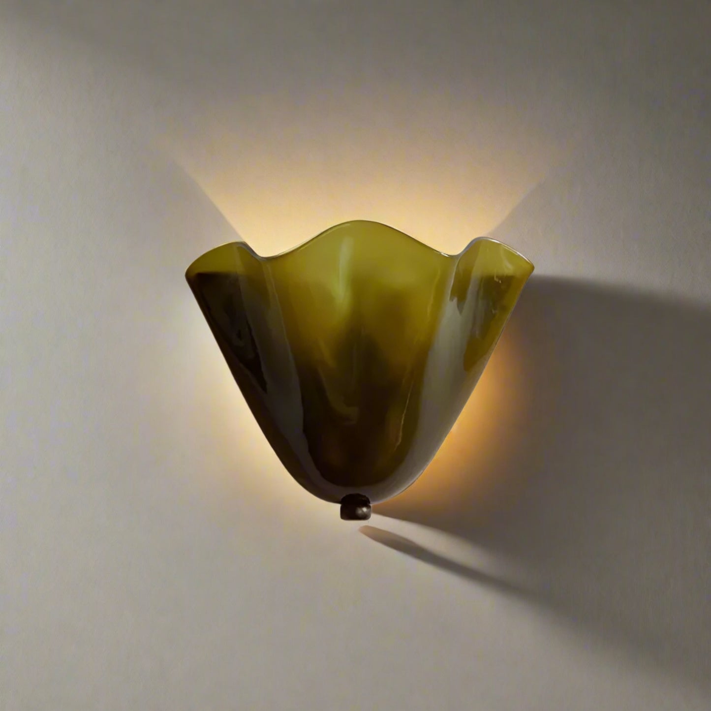 Green and brown wavy light fixture on a beige background 