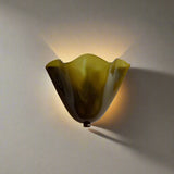 Green and brown wavy light fixture on a beige background