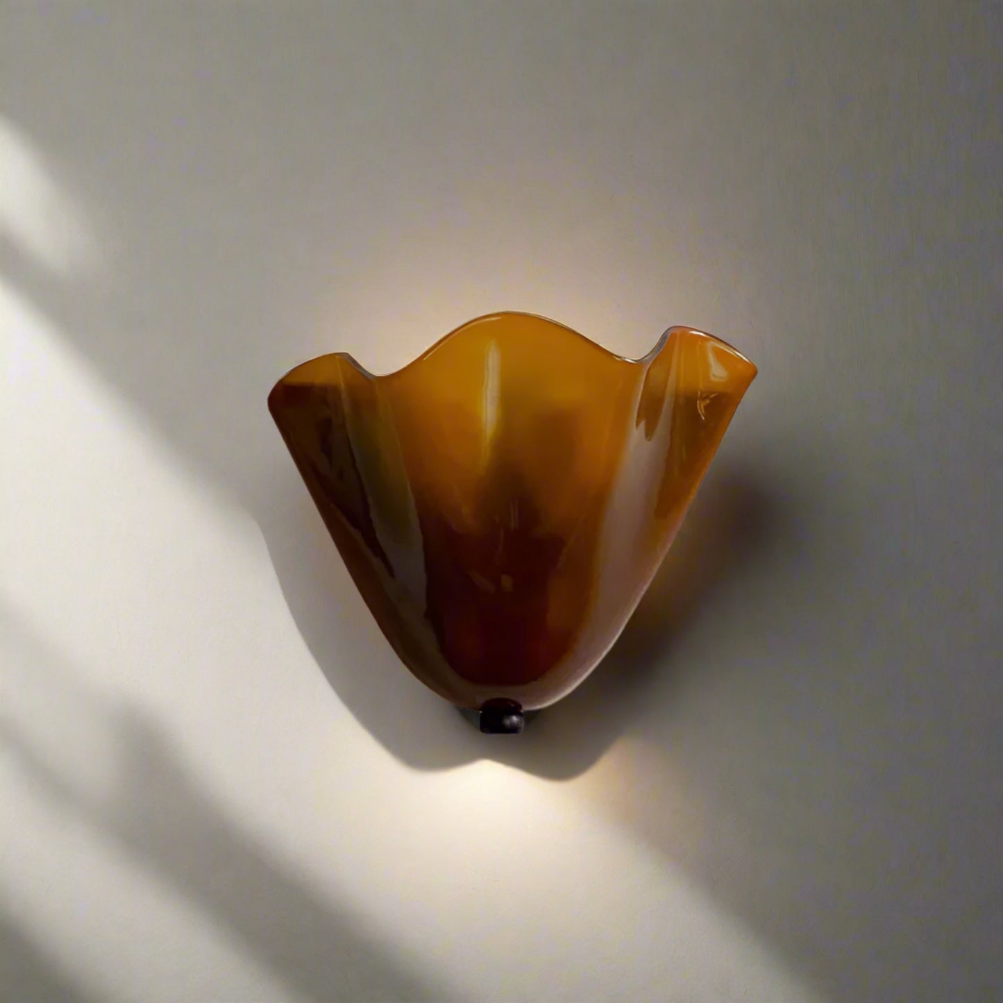 Brown decorative wall light fixture on a beige background 