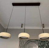 Three concrete pendant lights hanging from a ceiling