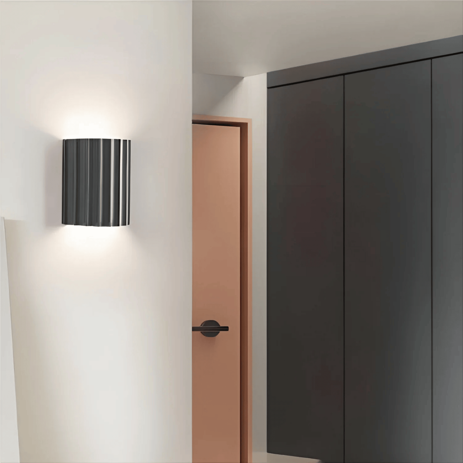 Modern wall lamp on a white wall with a door and wardrobe in the background